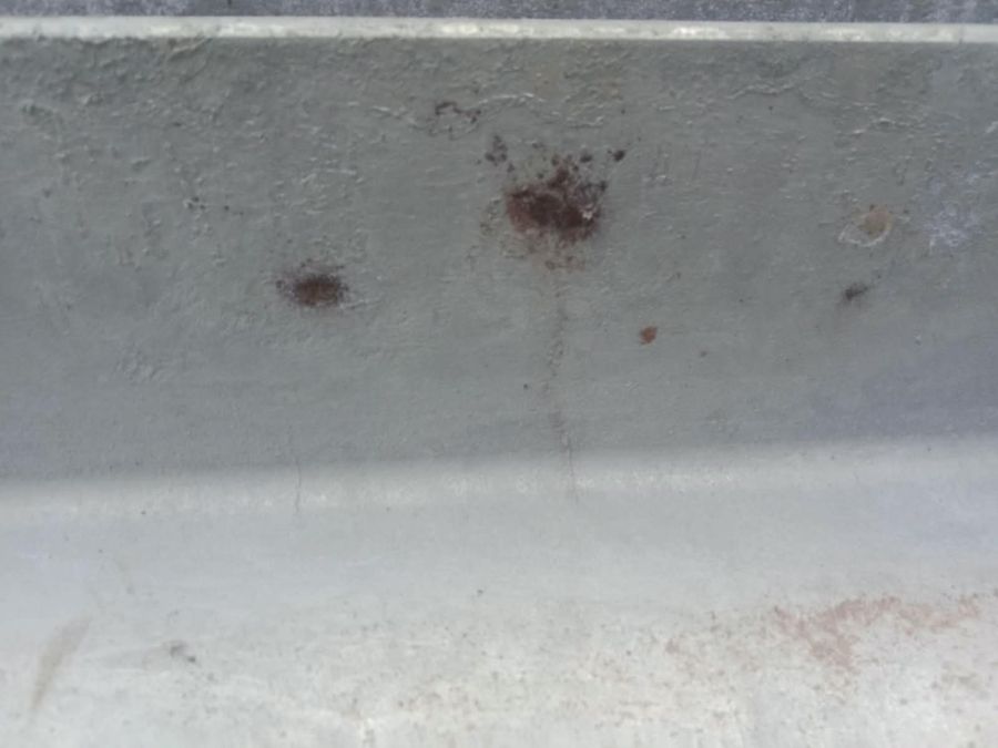 Galvanized channel with dark, rust-coloured spots on the coating