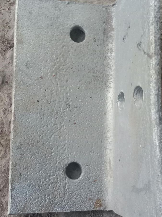 Galvanized angle with a blistered, pitted coating surface