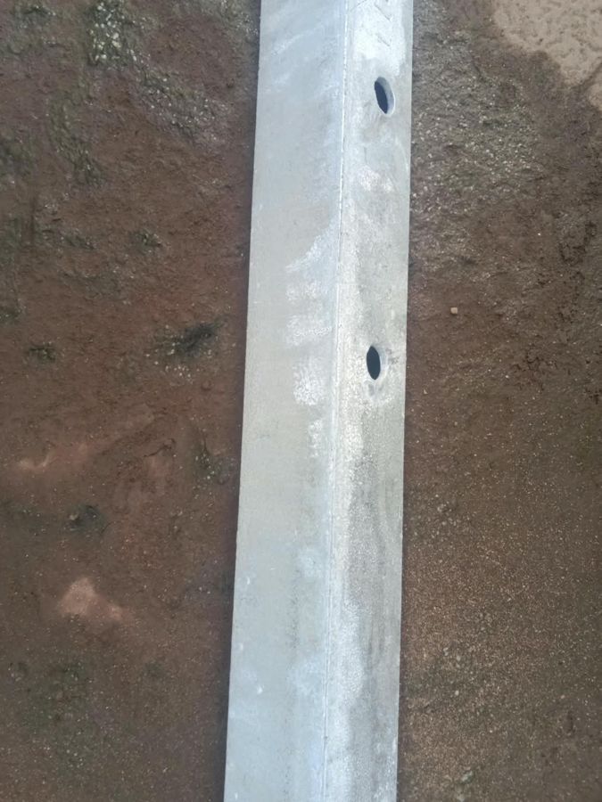 Galvanized angle with a white rust bloom on its face