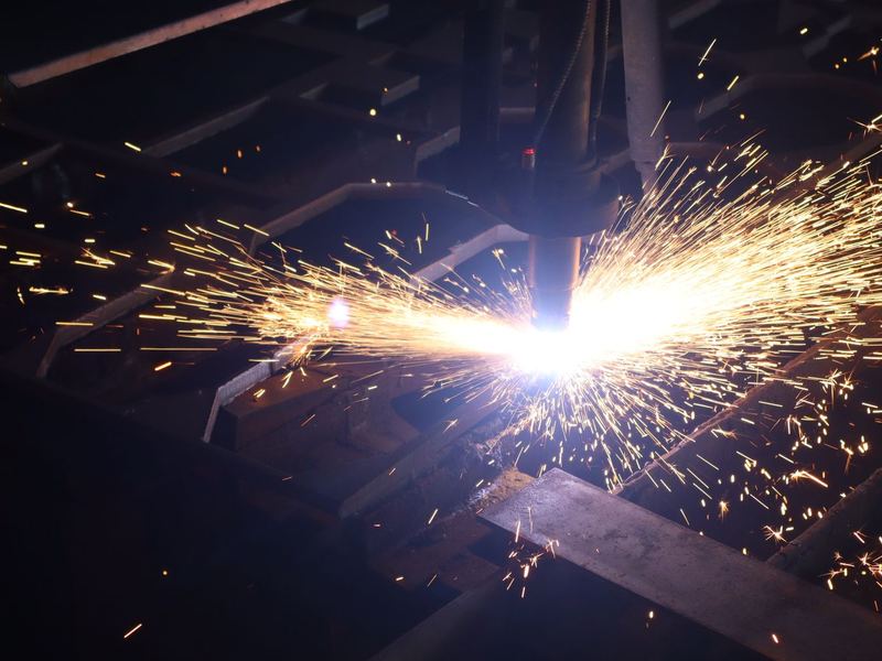 The cutting head at work. The plasma head following the programmed profile. Nesting is done from the drawing so offcut is minimised on long runs.