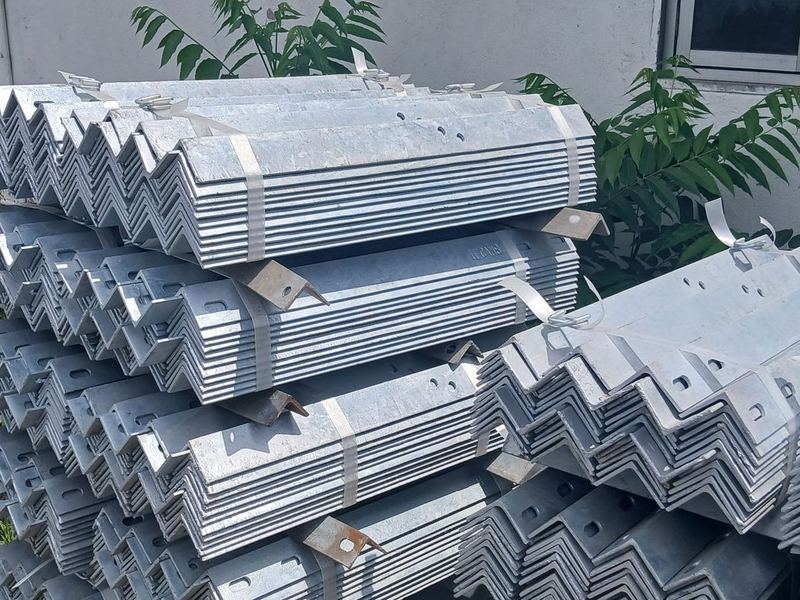 Galvanized angle and cleats. Punched and galvanized angle sections, banded into bundles. Steel to IS 2062, galvanized to IS 2629 and IS 4759.