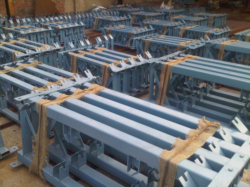Painted frames ready for despatch. Not everything is galvanized. Painted fabricated frames, hessian-wrapped at the bearing faces, ready to load.