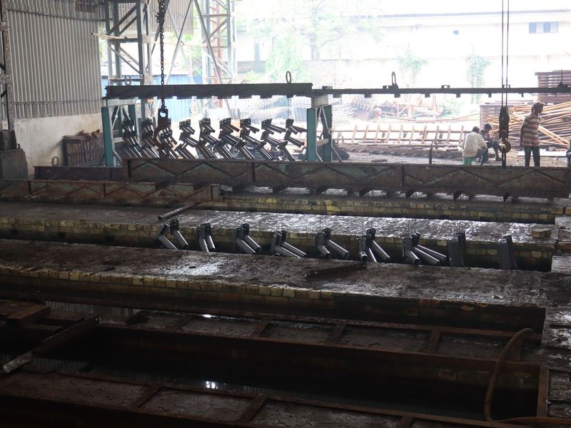 The galvanizing line. Jigged members on the line above the pre-treatment and galvanizing tanks. Degrease, pickle, flux, dip, quench - every batch takes the same route through...