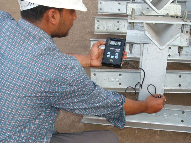 Reading the coating thickness. Dry film thickness taken on galvanized cleats with a Coatmeasure M1 gauge, batch by batch, against IS 2629 and IS 4759. The standards set a...