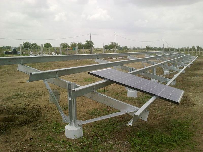 Module mounting structures on site. Galvanized solar module mounting structures erected in the field, on cast foundations.