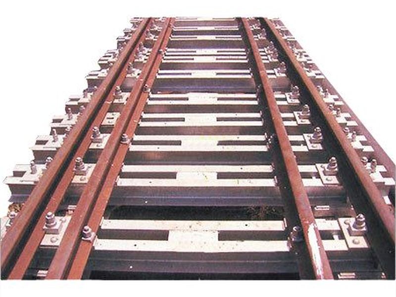 A track panel on channel sleepers. Rail laid and fastened on galvanized steel channel sleepers, gauge held by the fastening assembly at each seat.